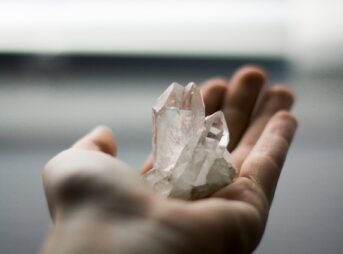 person holding crystal stones