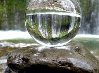 clear glass ball on brown rock